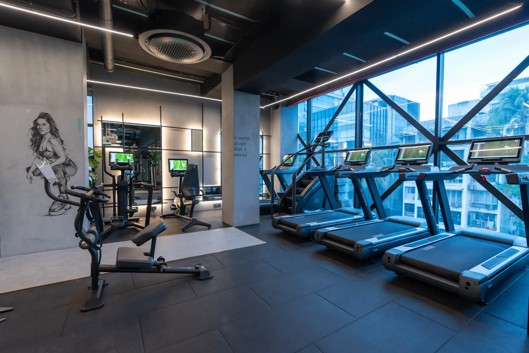 Cardio deck with floor-to-ceiling city views at MMA Matrix Gym, Mumbai