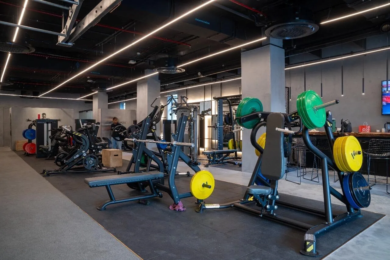 Strength training floor with colour-coded plates at MMA Matrix Gym
